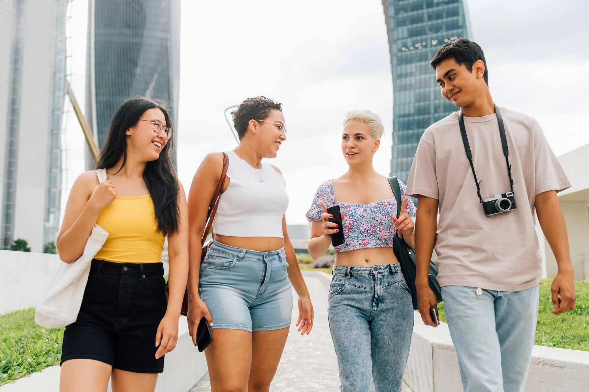 A group of young friends of different backgrounds outdoors, laughing together