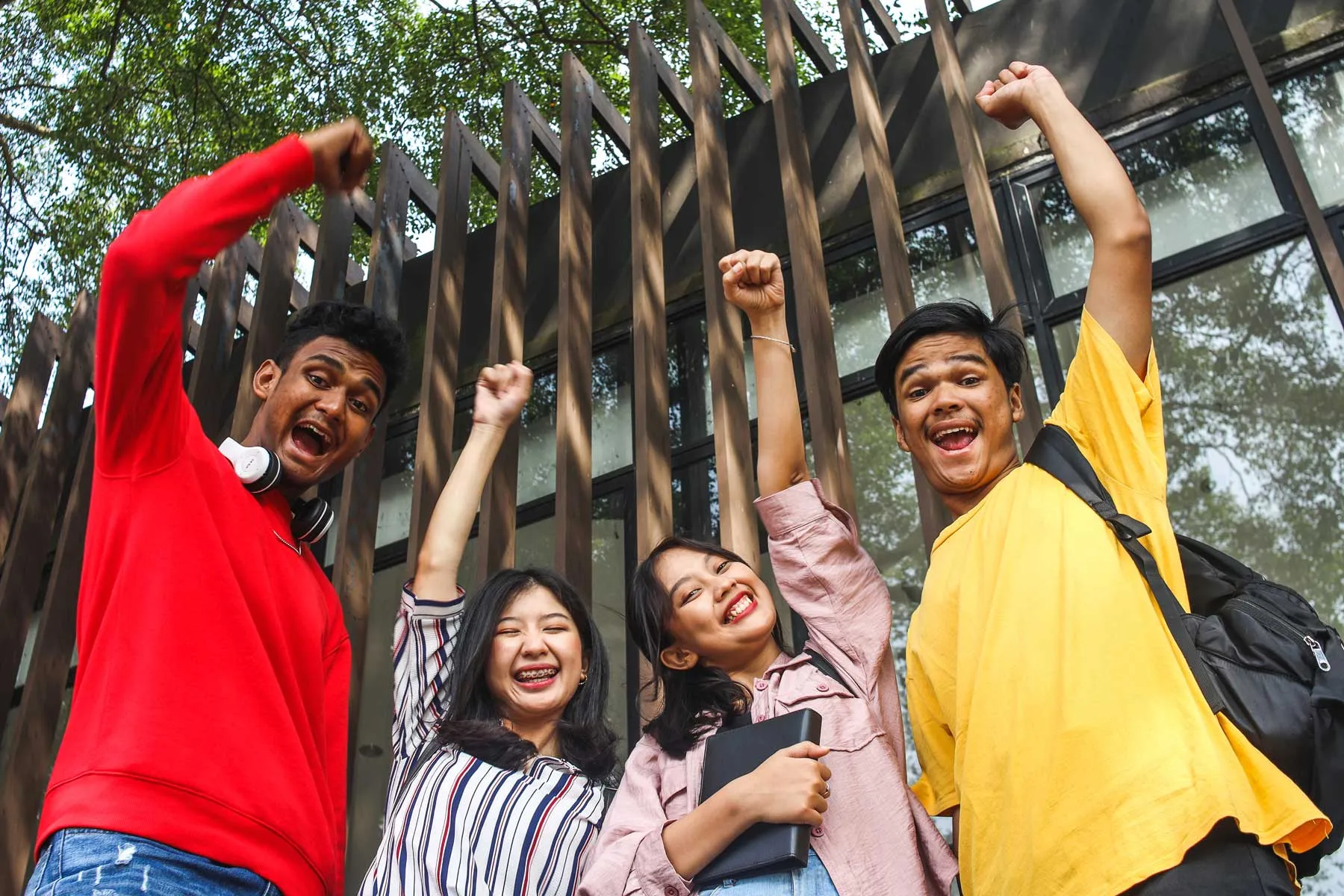 A diverse group of university friends celebrating together