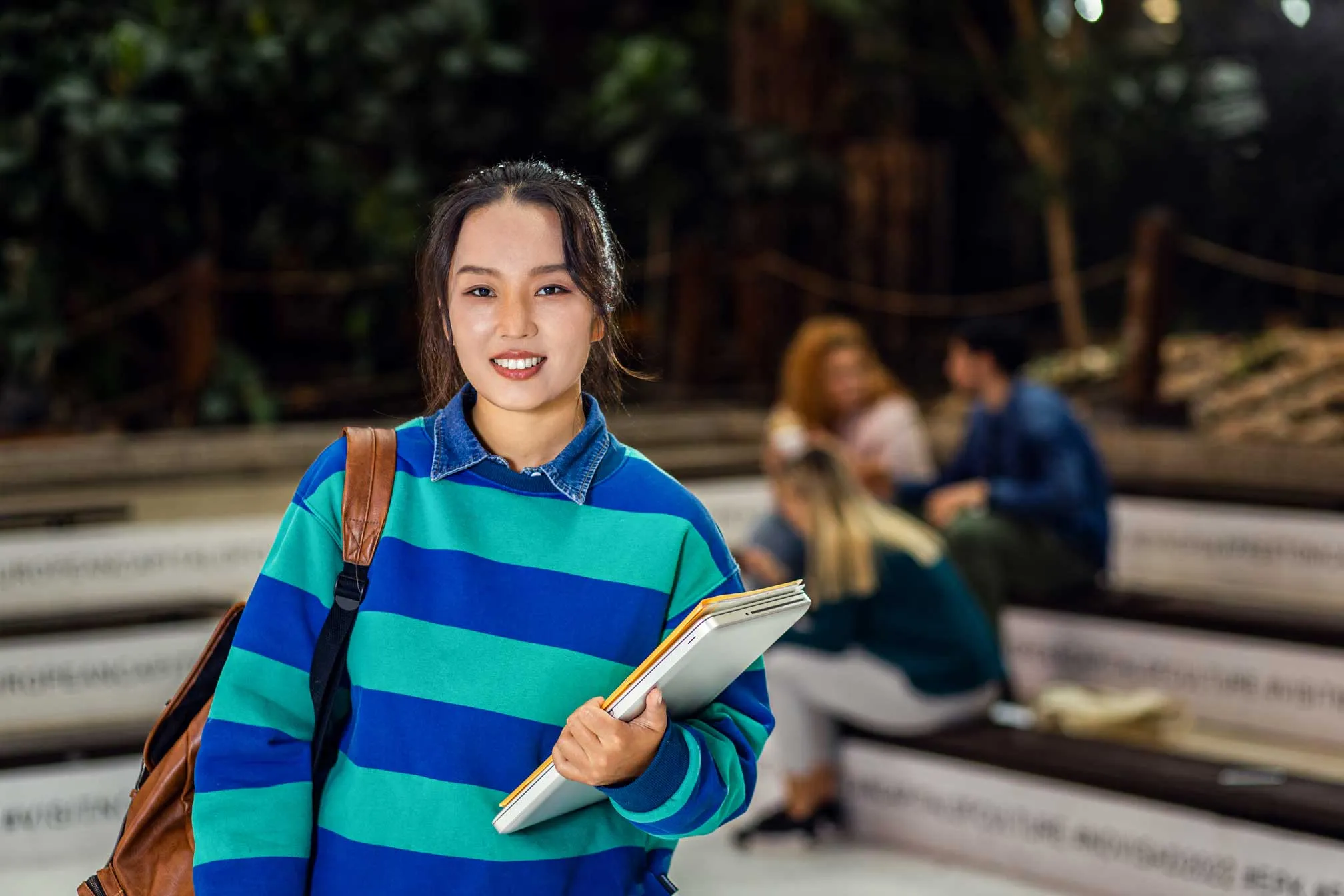 A smiling female student on a university campus