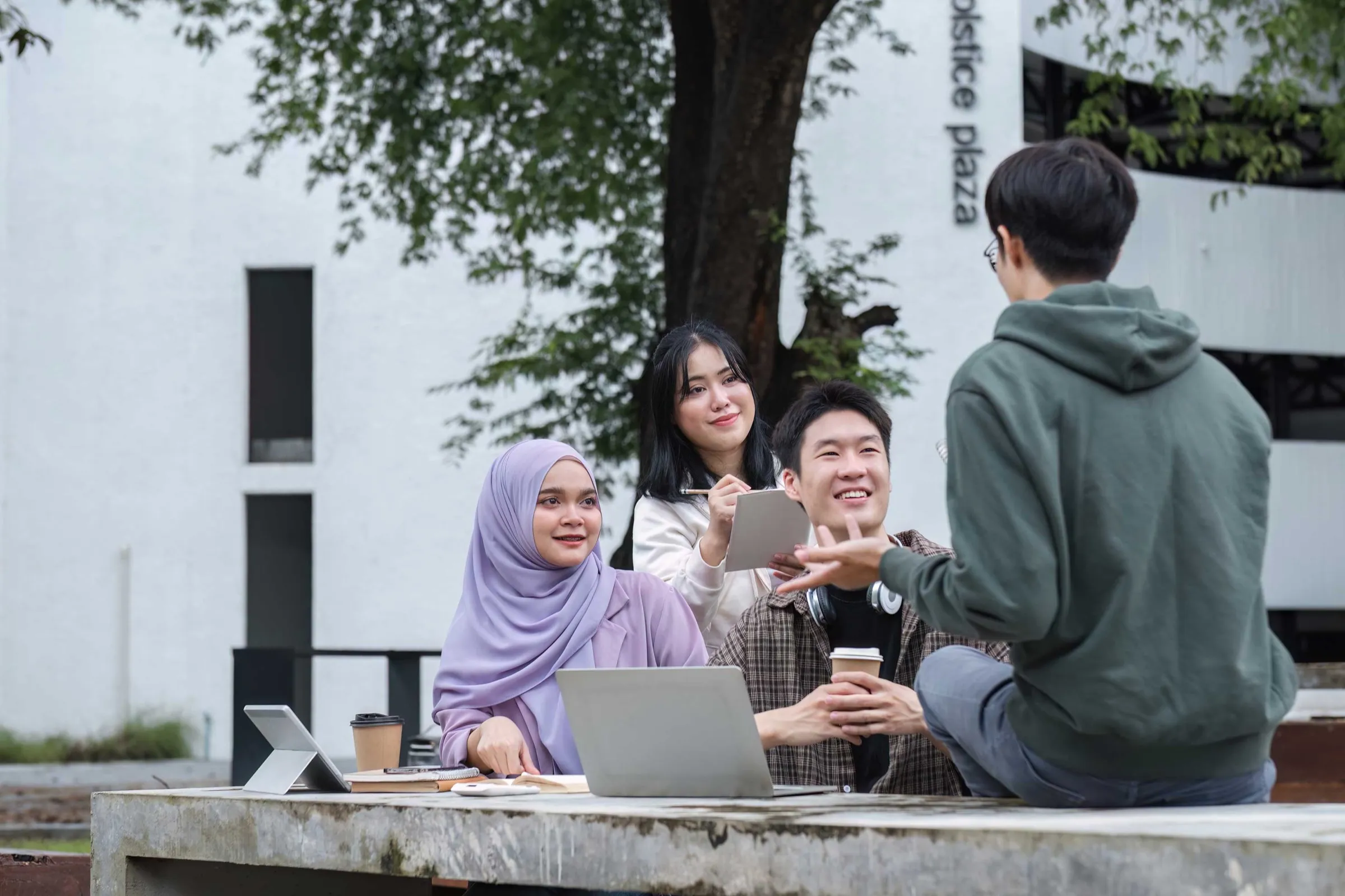 A multiracial group of students on a college campus